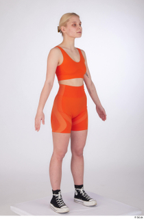 Unaisa a-pose dressed orange bike shorts orange sports bra standing…